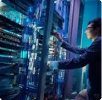 Engineer working on data centre networking racks